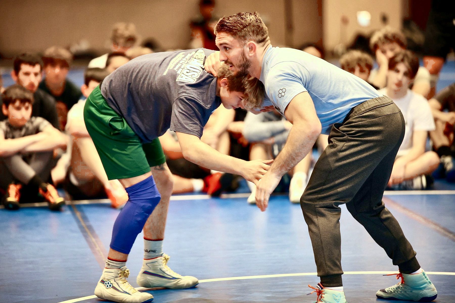 A coach and a camper in a stance during a technique demo at Ken Chertow Gold Medal Training Camp