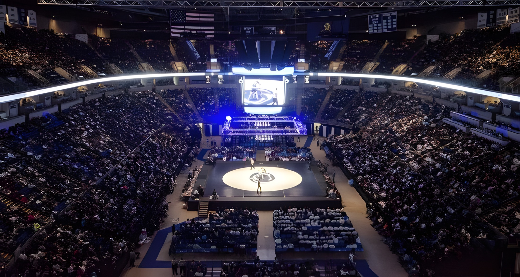 A packed arena watching a match, the stage Ken Chertow's summer wrestling camp athletes train for