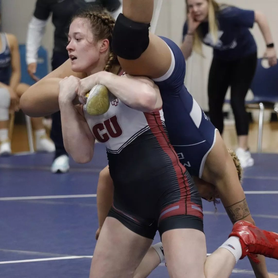 Kendra Thompson in a Campbellsville singlet driving through a takedown, SuperGirl girls wrestling summer camp coach