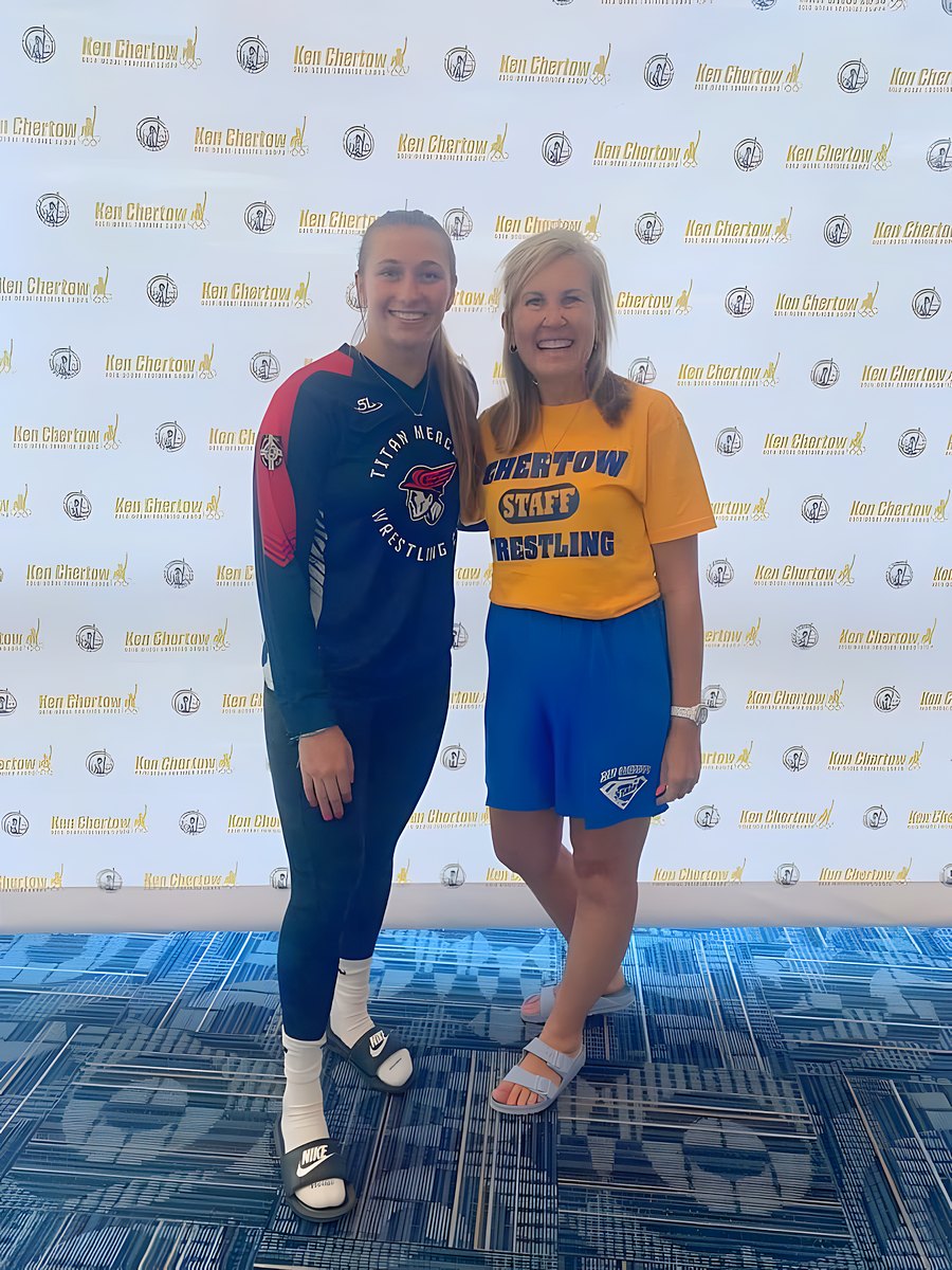 Beth Chertow smiling with a SuperGirl camper at the Ken Chertow photo wall